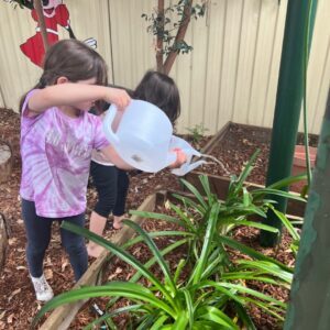 kid watering plants